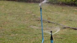 Water sprinkler showering grass.  Part 4 Stock Footage