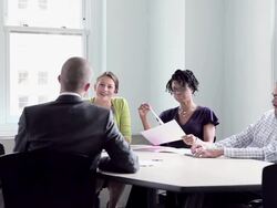 MS DS coworkers discussing project in office conference room Stock Footage