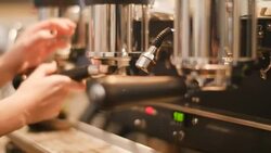 Female barista making cup of coffee in cafe Stock Footage