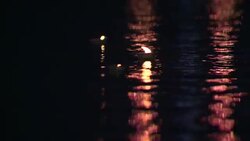 Diyas float in a calm river during Diwali in India. Stock Footage
