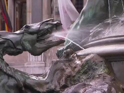 Water sprays from the mouth of a dragon on a fountain. Stock Footage