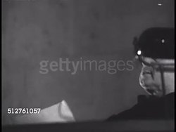 1940s: DOMINICAN ORDER: Order of Preachers (Ordo Praedicatorum) lecture auditorium,  students in audience, some in friars habits, others in priest robes sitting, listening then applauding. Unidentified male overseeing lecture hall, still reading from Instructional Video