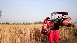 Female farmer working on laptop in the field Stock Footage