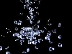 MS SLO MO Shot of Diamonds Falling against Black Background / Calvados, Normandy, France Stock Footage
