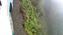 A truck drives along a precarious mountain road with a sheer drop off. Stock Footage