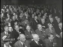 1940: WILKIE SPEAKS: MS Wendell Wilkie (1892-1944) w/ American flag BG saying, 'Our way of life is in competition with Hitler's way of life...' promises to beat him in the 'American way' WS Audience applauding. WWII. Instructional Video