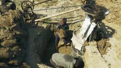 Men in Bangladesh dig soil and clay mixed with water which is churned by machine in preparation of brick making  Stock Footage