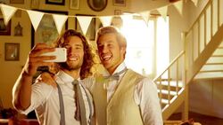 Groom and groomsman taking selfie with camera phone Stock Footage