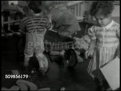 1946: CARDINAL MCCLOSKEY SCHOOL & HOME FOR CHILDREN: Children playing in room w/ tables, toys. Child w/ mop, another w/ wagon, girl w/ wooden square. Nun overseeing children washing hands, face, combing hair at sinks. Institution, orphans, foundling. Instructional Video