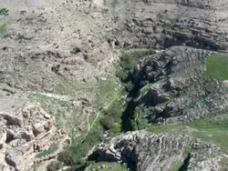  WS AERIAL PAN View of  wadi desert  / Qumran,  Norrn Judea Desert, Israel Stock Footage