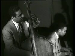 B/W black men playing bass fiddle + piano Stock Footage