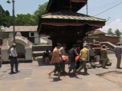 MS TD ZO ZI People spinning prayer wheel on walkway outside Boudhanath Stupa / Kathmandu, Central Region, Nepal Stock Footage