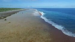 Aerial view moving forwards across the outer reef and breaking waves on Ahe Atoll Stock Footage