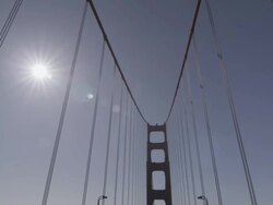 Driving shot of the Golden Gate Bridge midday , then Pan up pillar. Stock Footage