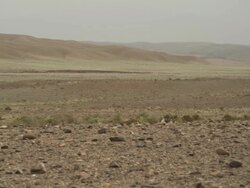 Wide, expansive shot of deserted land and mountains in the background. Stock Footage