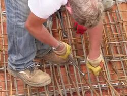 MS Shot of workmen still road tying in metal wire at house construction / Hermeskeil, Rhineland-Palatinate, Germany Stock Footage