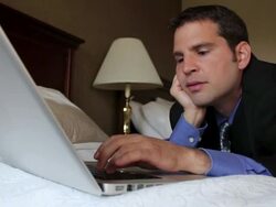 CU Man sleeping on bed working on laptop / Portland, ME, United States Stock Footage