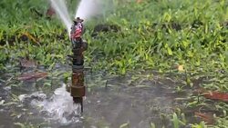 Water sprinkler showering grass.  Part 6 Stock Footage