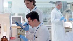 Scientists using digital tablet for experiment in laboratory Stock Footage