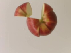 Apple spins and free-falls to table and slices separate Stock Footage