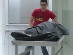 MS Shot of Mexican CSI deliver body to coroner AUDIO / Ciudad Juarez, Juarez, Mexico Stock Footage