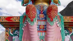 Tilt up to the 32 metre statue of Maitreya Buddha near Diskit Monastery facing down the Shyok River towards Pakistan in Nubra Vally, India Stock Footage