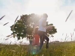 SLO MO Mother and daughter running in grass Stock Footage