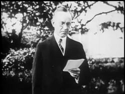 B/W 1924 President Calvin Coolidge with eyeglasses reading speech outdoors during re-election campaign Stock Footage