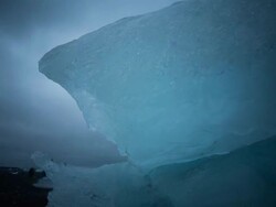 Timelapseof sunset at Jokulsarlon Bay with icebergs floating by. Clouds move in the sky obscuring the sun. Shot is wide. Stock Footage
