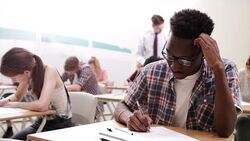 Pensive boy taking test in classroom Stock Footage