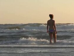 MS Shot of couple walking in sea for swimming, North Sea North Frisia, / St. Peter Ording, Schleswig Holstein, Germany Stock Footage
