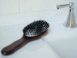 Hairbrush on bathroom sink Stock Footage