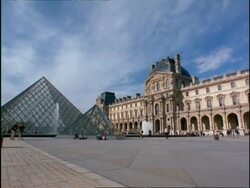 WA view of people walking amongst Glass Pyramids at the Louvre, Paris Stock Footage