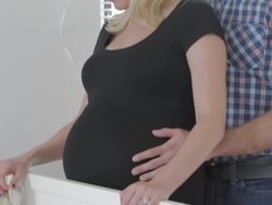 MS TU Pregnant woman contemplates her future while standing over crib and handling new toy. Her husband enters and caressing her belly / Sunnyside, Queens, New York, United States Stock Footage