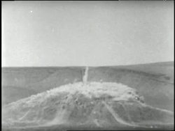 Earth explodes in clouds of dust during an underground atomic bomb test. News Clip