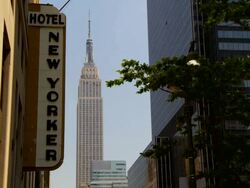 Skyline with the New Yorker Hotel and the Empire State Building midday. Stock Footage