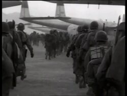 B/W 1950's soldiers with gear walking toward airplanes / Korea / NO SOUND Stock Footage