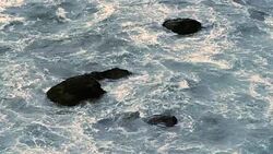 Rocks and surf slow motion Stock Footage