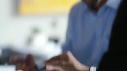 Business partners study graphs and figures on tablet computer Stock Footage