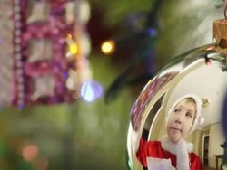 boy decorates the Christmas tree toys Stock Footage