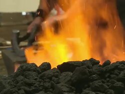 CU Shot of participators picking hot iron from fire in blacksmith competition at Calgary Stampede / Calgary, Alberta, Canada Stock Footage