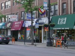 WS Street lined with shops day Stock Footage
