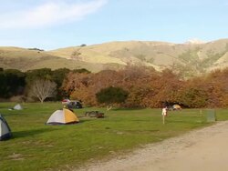 A group of tents set up in Andrew Molera State Park on a sunny day in Big Sur. Stock Footage