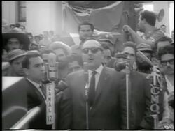 B/W 1959 (President Urrutia?) in sunglasses making speech outdoors / post-revolution Havana Stock Footage