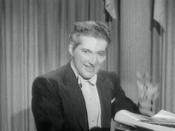 1950s MS Liberace playing piano and talking to camera Stock Footage