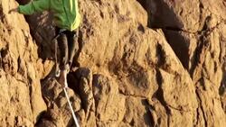 Man traverses highline stretched above sea below Stock Footage