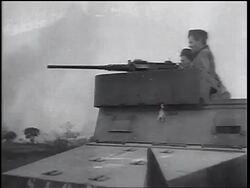 B/W 1960s two soldiers on tank shooting gun / Vietnam War / newsreel Stock Footage