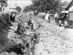 B/W 1934 men working in ditch in WPA sewage construction project / documentary Stock Footage