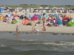 WS Shot of crowd of people along beach side, North Sea North Frisia, / St. Peter Ording, Schleswig Holstein, Germany Stock Footage