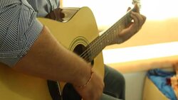 Businessman playing the guitar Stock Footage